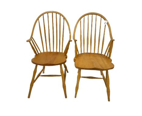 Two light elm American style Windsor carver armchairs, stick and hoop back with dished seats, turned supports joined by swell