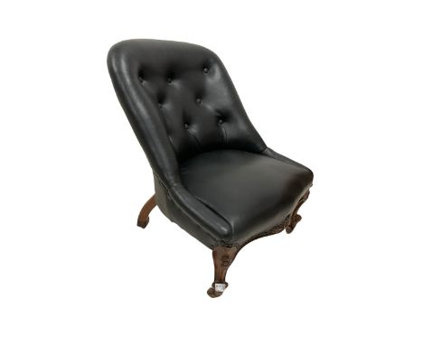 Nursing chair, upholstered in black leather with carved apron,  raised on cabriole supports, terminating in ceramic castors 
