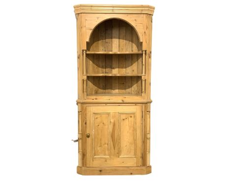 Victorian style barrel back corner cabinet, the cornice over two shelves flanked by turned columns, leading to cupboard with 