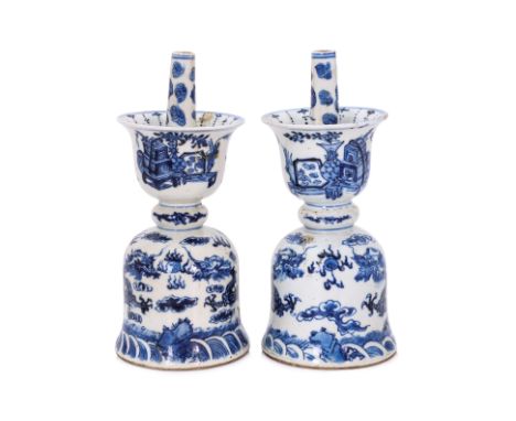 A PAIR OF BLUE AND WHITE DRAGON CANDLE HOLDERS
Both in double bell shape with protruding stem, decorated in two flying dragon