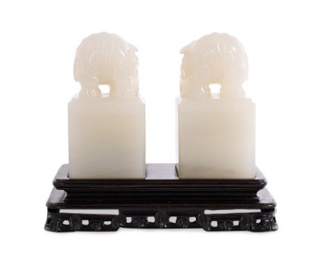 A PAIR OF SMALL CARVED WHITE JADE SQUARE ELEPHANT SEALS
20th century, an opposing pair of square form seals with rounded corn