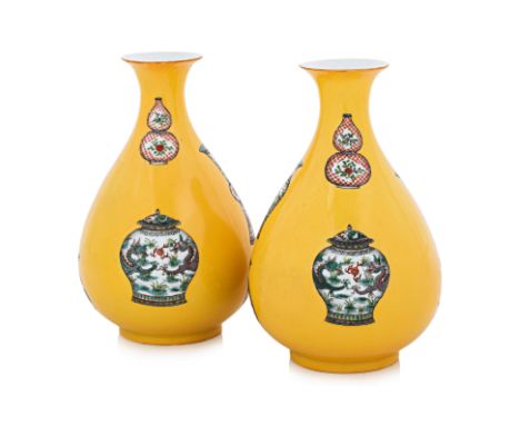A PAIR OF YELLOW GROUND PEAR SHAPED BOTTLE VASES 20th century, thinly potted, each with white ground reserves of enamel decor