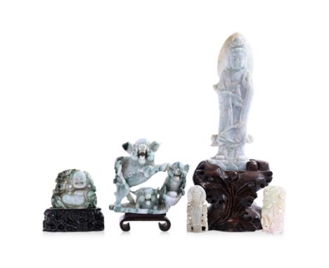 A GROUP OF JADE CARVINGS
Including a pale green figure of Guanyin, set on a naturalistic carved wood base; a green and white 
