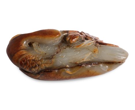 A CARVED CELADON AND RUSSET JADE CRANE WITH FISH Pale celadon and russet jade, modelled as a crane turned toward itself with 