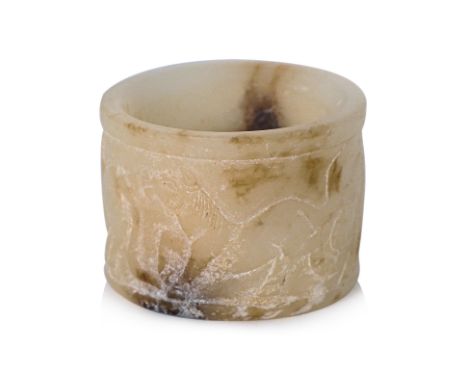 A JADE ARCHER'S RING WITH HORSES
White jade with russet inclusions, the exterior decorated in four low-relief carved horses
3