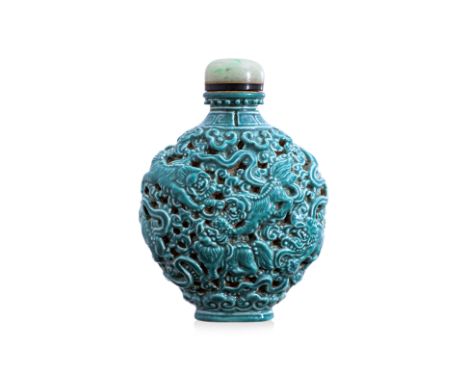A TURQUOISE GLAZED PORCELAIN SNUFF BOTTLE Late Qing, a moon shaped porcelain bottle decorated in moulded foo lions playing am