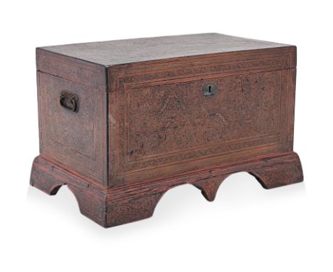 A BURMESE LACQUERED TRUNK
Decorated in red and black with an elaborate scene within foliate borders, twin curled iron handles