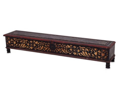 A BURMESE TEAK MANUSCRIPT BOX
Rectangular box, red painted and decorated in gilt foliate pattern, sitting on four octagonal f