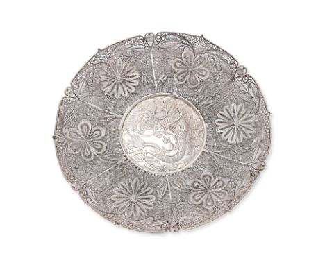 A FILIGREE SILVER DRAGON DISH
Circular dish with barbed sides and six panels of floral decoration, recessed central medallion