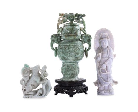 A GROUP OF THREE JADE CARVINGS
Including a pale lavender figure of Guanyin, standing with a serene expression, holding a stri