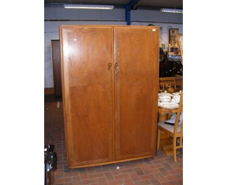 An Ercol two door wardrobe - width 122cm (key in office)CONDITION REPORTDimensions:Height, 182cmWidth, 122cmDepth, 55cmWe hav