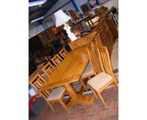 A large oak dining table - length 215cm - with eight cushioned chairs 