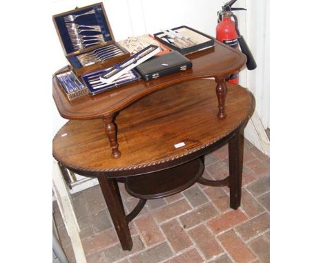 An oval coffee table together with a mahogany bed table