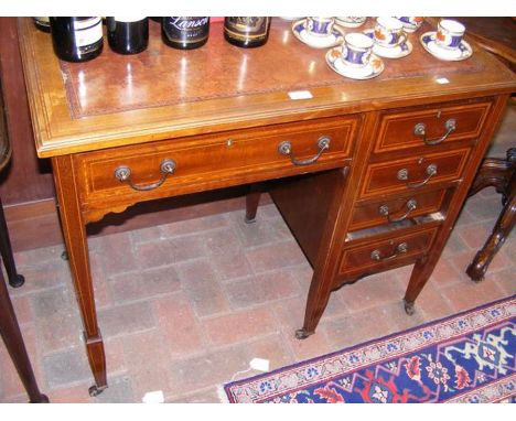 An Edwardian ladies writing desk with five drawers to the front