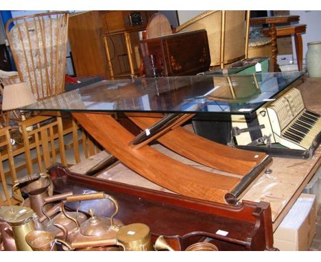 A contemporary glass top coffee table with wooden and chrome under tier 