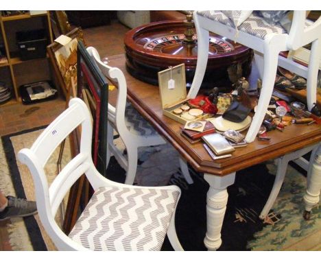 A walnut dining table with painted legs - length 145cm, together with five white painted dining chairs 