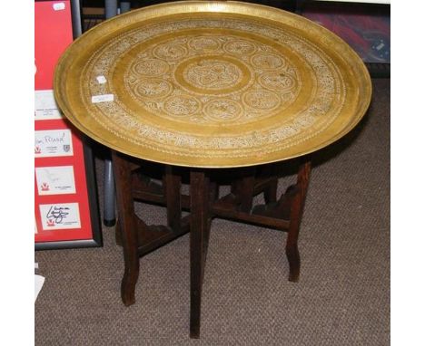 A Middle Eastern table with decorative brass top - diameter 58cm 