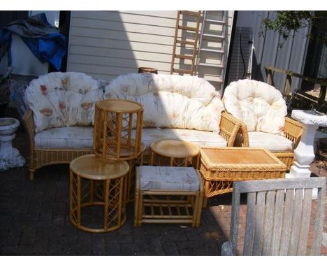 A cane conservatory suite consisting of two seater settee, two armchairs, coffee table, four occasional tables and a stool