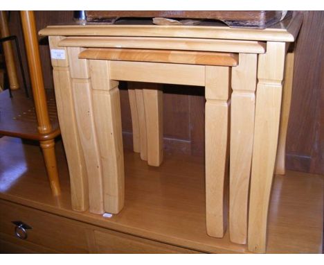 A nest of light wood occasional tables 