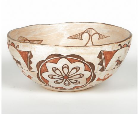 Large Zuni ceramic dough bowl, polychrome decorated in black and orange with animals and geometric motifs along the interior 