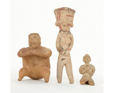 Group of three pre-Columbian Colima ceramic figures, one standing and two seated. The standing figure with remnants of polych
