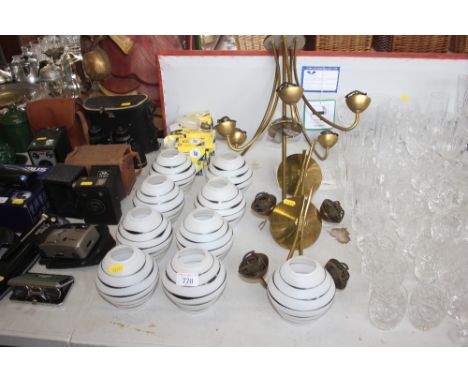 A brass light fitting with two matching wall lights and glass shades