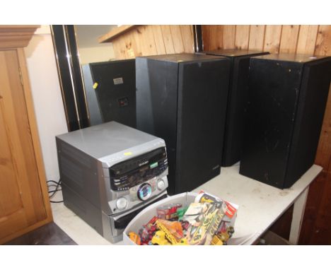 A pair of speakers; a Pioneer speaker and a Sharp stereo