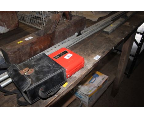 A Cowley automatic level and measuring stick