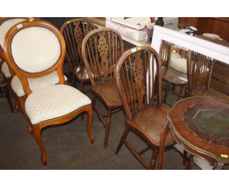 A set of three elm seated stick and wheel back chairs