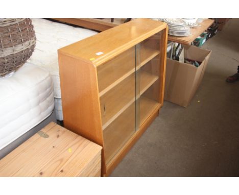 A light oak bookcase and sliding glass doors