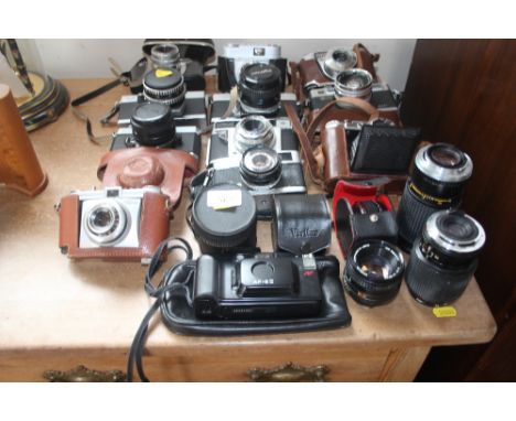 A collection of various cameras to include Olympus Trip 35; Yashica; Practica; Minolta etc. and various lenses