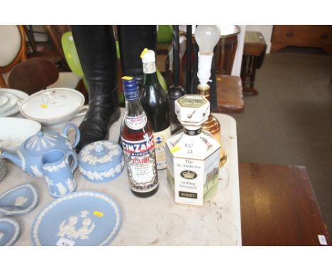 A bottle of Cinzano, one other bottle, a Bells Scotch Whisky decanter converted to a table lamp and a St. Andrew's golfing de