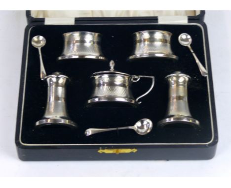 A boxed George V silver cruet set 
Comprising two salts, two pepperettes and one mustard pot, together with three spoons all 