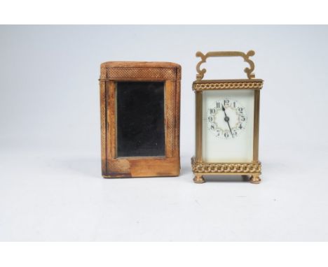 A late 19th Century gilt metal carriage timepiece with travelling case
With a 5cm white enamel dial with Arabic numerals pain