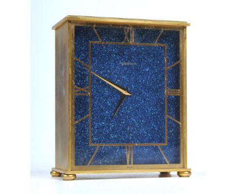 A Jaeger Le Ccultre Faux Lapis mantel timepiece
The upright rectangular gilt metal case with a glazed panel decorated in gilt