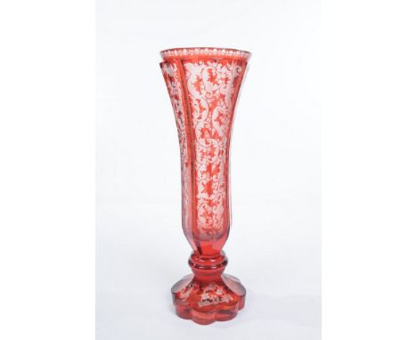 A Bohemian ruby glass vase, late nineteenth century.  Of flaired octagonal trumpet form with a raised rim, each tapering side