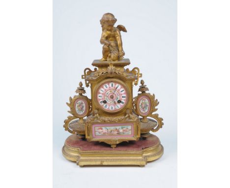 A 19th Century French gilt metal and porcelain mantel clock
With a 8cm rose pink porcelain dial with Roman numerals within ro