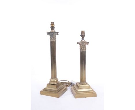 Two Victorian brass Corinthian column table lamps. The first with a stepped square plinth rising to a fluted shaft with a cir