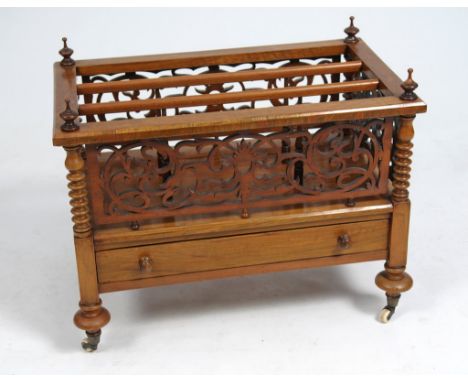 A Victorian Bur Walnut Canterbury
The rectangular top with turned finials embracing a divided interior above pierced foliate 