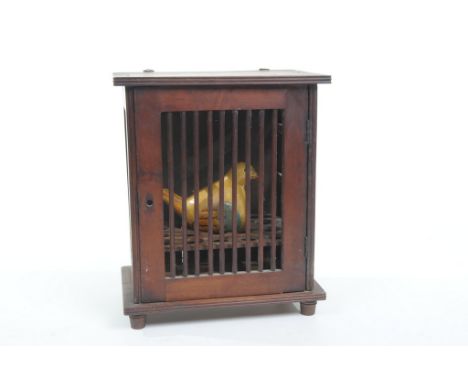 An unusual nineteenth century stained mahogany hanging or table top egg cupboard. The rectangular reeded top above a door wit