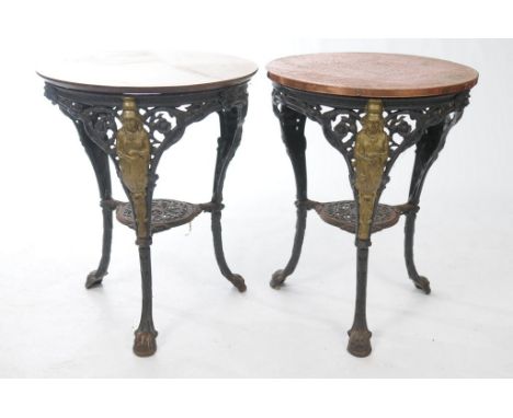A pair of Victorian cast iron Brittania pub tables
The first with a 58cm burnished copper top each with leaf and flower borde