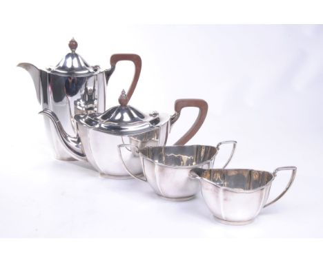 A George V four piece silver tea and coffee service
Comprising coffee pot, teapot, milk jug and turn handled sucrier of simpl