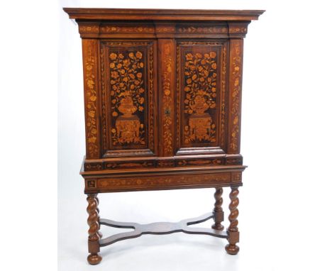 An 18th Century Dutch marquetry cabinet on stand with later alterations 
With a cavetto cornice inlaid with a trail of flower