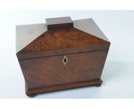 An early 19th Century yew wood and mahogany sarcophagus shape caddy
The hinged pyramidal top with a rectangular plinth, silve