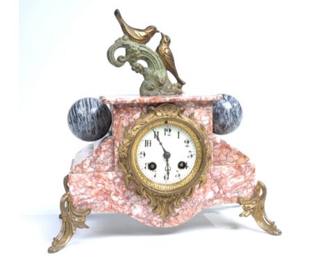 An attractive French variegated rouge marble mantel clock.  With an 8cm white dial, blued metal hands and Arabic numerals, th