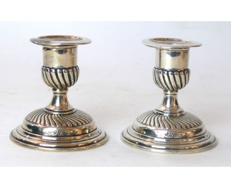 A pair of Victorian silver dwarf candlesticks
The campana shaped candle nozzle extending to a spreading circular base with sp