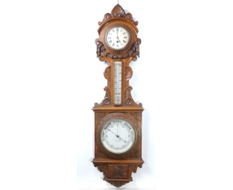 A Victorian carved oak combined timepiece and barometer.  With a 12.5cm white dial with Roman numerals the  single-train key-