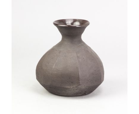 JANET LEACH (1918-1997) for Leach Pottery; a cut sided stoneware bottle covered in manganese glaze, impressed JL and pottery 