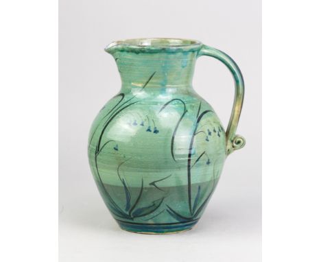 PHILIP LEACH (born 1947) for Springfield Pottery; a large slipware jug with scroll handle covered in green glaze with black a