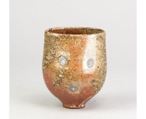 ALEX SHIMWELL (born 1980); a stoneware bowl squeezed to an oval at the rim covered in shino and ash glaze, side fired on shel